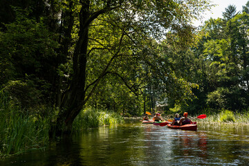 Fototapeta na wymiar Kayaking trip on the beautiful Czarna Hańcza River, Poland, tourist attraction, two canoes on the river