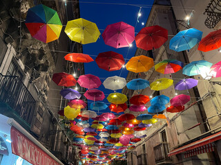 colorful umbrellas lit up at night against the sky