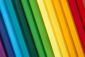 Multi colored Crayons in a row like rainbow. Colourful pencils background.