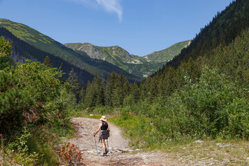 Fototapeta premium Hiker woman on mountain trail. Rackova valley, Tatras mountains. Slovakia. Mountain tourism