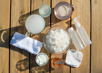 Homemade skincare cosmetic with rice water. Bottles of rice water, honey, milk, towel, cotton pads.