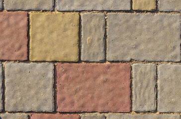 The texture of the surface of the wall tiled in different colors.