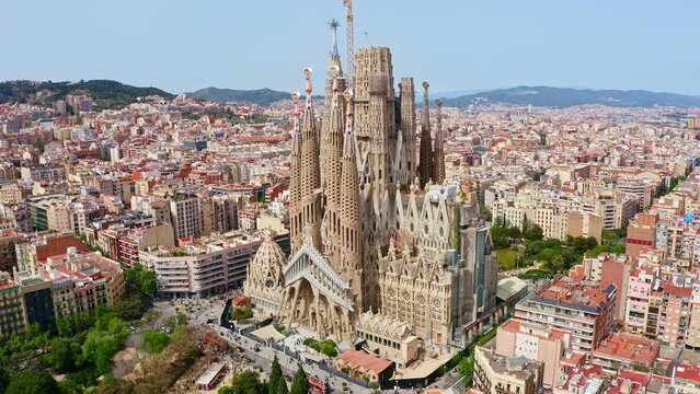 Panorama aerial view flying drone shot over famous Spanish city Barcelona tourism traveling place top outside exterior facade catholic religious church La Sagrada Familia cathedral temple in Spain