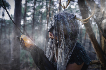 Forest witch in a pine forest