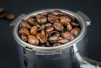 Detailed macro shot of coffee beans in portafilter.