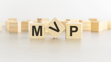wooden cube with the letter from the mvp word. mvp - Minimum Viable Product
