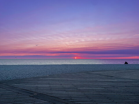 Beautiful sunset or sunrise iver the sea. Colorful cloud band above the horizon.