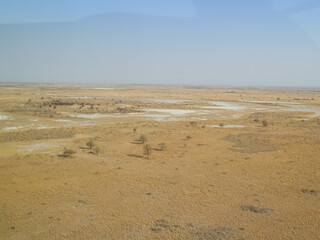 Aerial views of expansive flat landscape while flying over