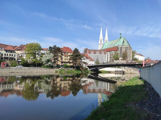 2022-04-29 view of the old town with gothic medieval St. Peter and Paul Church or Peterskirche with two white towers from the side of the river neisse. Goerlitz, Germany