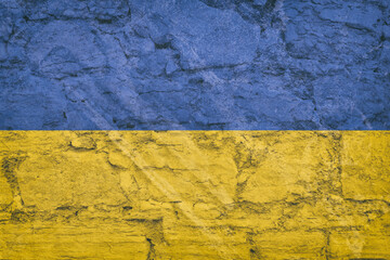 Ukraine flag on stone wall, grunge background. Ukraine flag depicted in bright paint colors on old relief plastering wall