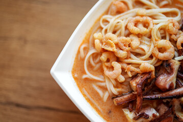 Spicy Asian soup with noodles, octopus and shrimp.