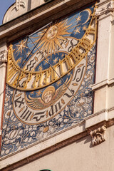Ancient sundial clock with golden decoration on the facade of a Renaissance building in Munich