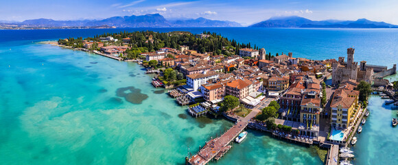Fototapeta premium Scenic lake Lago di Garda aerial drone view of Sirmione town and medieval castle Scaligero. Italy, Lombardy