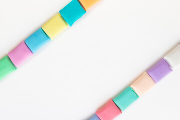 Colorful molded plasticine clay isolated on white background with copy space for text. Creativity children toys concept.