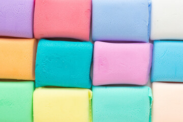 Colorful molded plasticine clay isolated on white background with copy space for text. Creativity children toys concept.