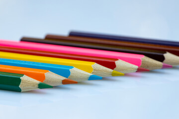 Colored crayons. Close up on the colorful tips of the crayons. Concept for school, back to school, pastels, colors, homework, creativity, art, painting, drawing and kids.
