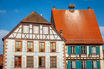 Stork nest in Colmar alsatian architecture at springtime, Eastern France