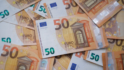 The background consists of many euro banknotes of different denominations. Finance and business concept