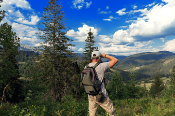 Traveler Man walks around mountains in sunny day.