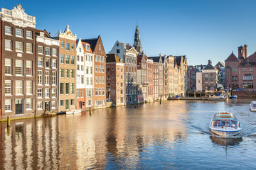 Amsterdam canal with boat and dutch architecture, Netherlands