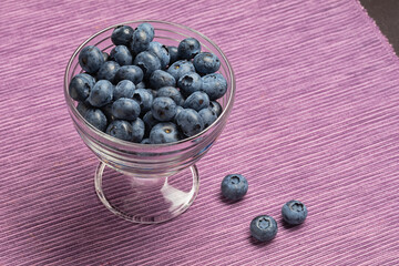 fresh ripe blueberries in glass bowl. Healthy eating and nutrition concept.