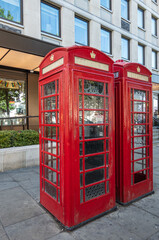London, UK- July 4, 2022: Trafalgar Square. Closeup of 2 red telephone boots still in operation