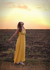 Obraz premium Cute young woman relaxed breathing fresh air, standing with closed eyes