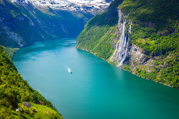 Ferry ship crossing Geirangerfjord and Seven Sisters Waterfalls, Norway - obrazy, fototapety, plakaty