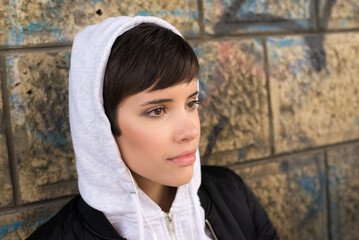 Portrait of young woman outdoors wearing hoodie