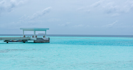 Concrete Pier and dock at tropical beach bay with turquoise water in Maldives Island 2022 