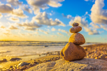 Stone tower on the beach with evening sunset light