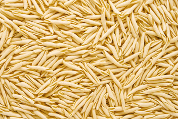 Food background. Dried trofie pasta from Liguria. Short twisted pasta, flat lay - obrazy, fototapety, plakaty