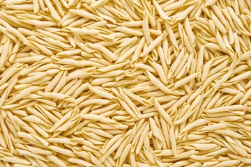 Abwaschbare Fototapete Ligurien Food background. Dried trofie pasta from Liguria. Short twisted pasta, flat lay