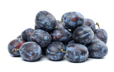 Stack of ripe blue plums on white isolated background