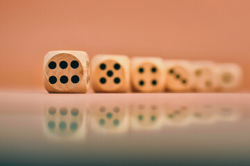 closeup shot of wooden dices with numbers on brown background 
