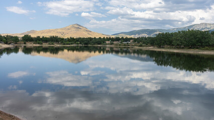 Spectacular pontoon reservoir in Segovia with clouds reflecting the water ( Spain )