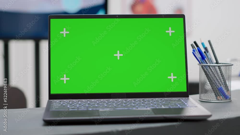 Poster laptop with greenscreen display on facility reception counter in waiting room. isolated mockup templ
