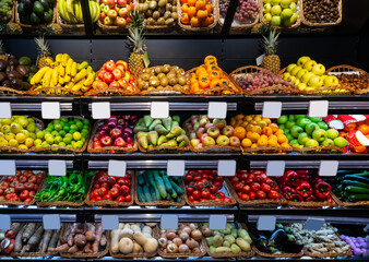 View of showcase with fresh ripe fruits and vegetables in greengrocery..