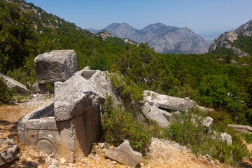 Ruins rock tombs at unique Southwest necropolis Termessos ancient city, Antalya in Turkey mountains