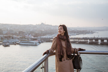 Fototapeta premium woman tourist enjoying the view of istanbul cityscape from top of the bridge