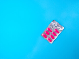 Top view Antibiotic pills that have been used are on a blue background with copy space.