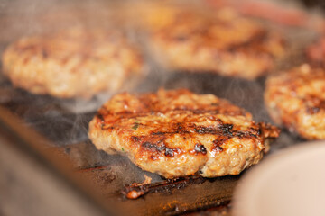 Focus on a hamburger cooked on a grill
