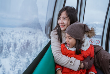 potrait of a family riding a cable car in the beautiful snowy mountain in turkey © Odua Images