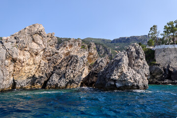 Fototapeta na wymiar Rocky seasides and ocean views of the coastline of Corfu on a sunny day