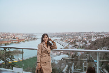 woman tourist enjoying the view of istanbul cityscape from top of the bridge