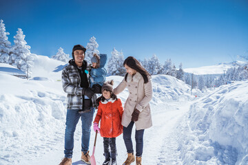 family walking together in winter with beautiful snow all over the place