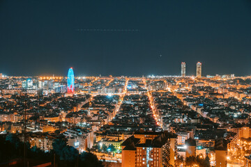 Barcelona skyline aerial at night view of city lights from Bunkers del Carmel, Eixample area with streets
