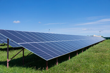 Solar batteries power station located in a field. Renewable energy clean and good environment.