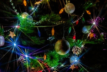 Christmas tree lights, multicolored garland in the dark on a holiday