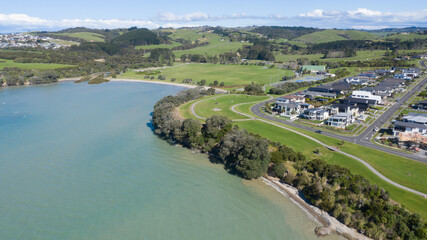 Fototapeta na wymiar Aerial View of Grahams Beach close to the park, Green Trees and Cliff in New Zealand - Auckland Area